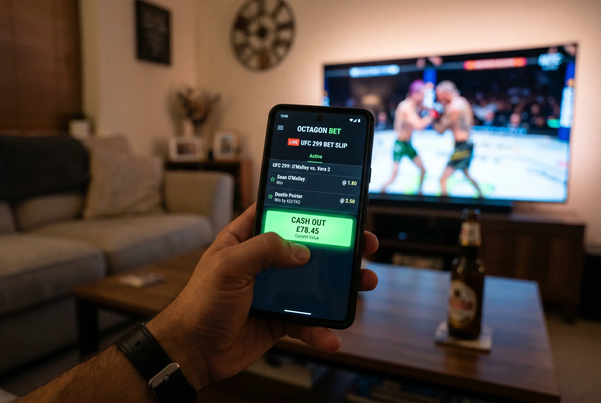 Smartphone screen showing a live UFC bet slip with a glowing cash out button during a fight